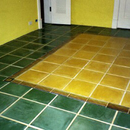 Dark green floor tile, hand painted striped 4" X 8" border around 12" yellow floor tile