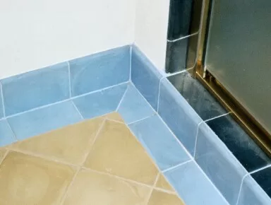Light blue bullnose 6" X 8" tile, 8" yellow floor tile, dark blue 8" wall tile