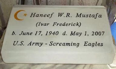 Grave marker, carved and painted on solid concrete block