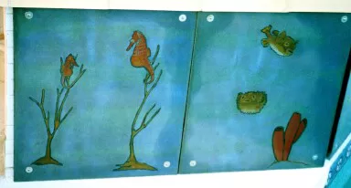 Painted fish mural installed above pool