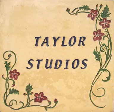 Carved and painted logo tile